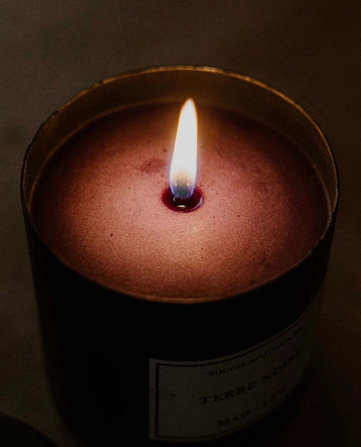 lit candle in darkness